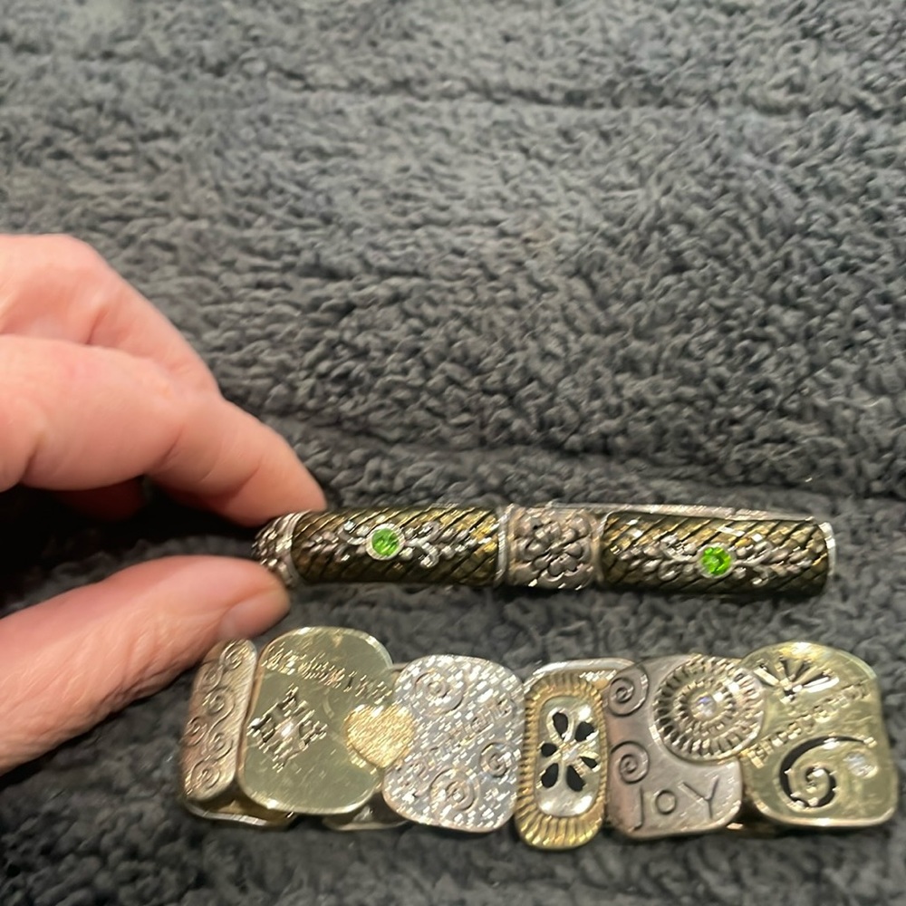 Two beautiful silver colored bracelets.